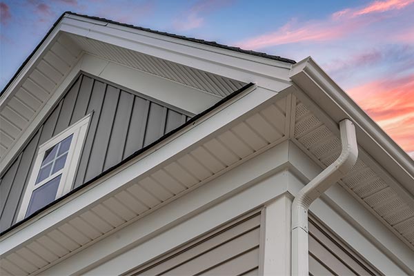 gutters and rain spout on top corner of house